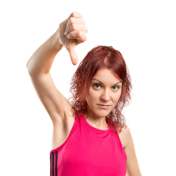 Young girl doing a bad signal over white background — Stock Photo, Image