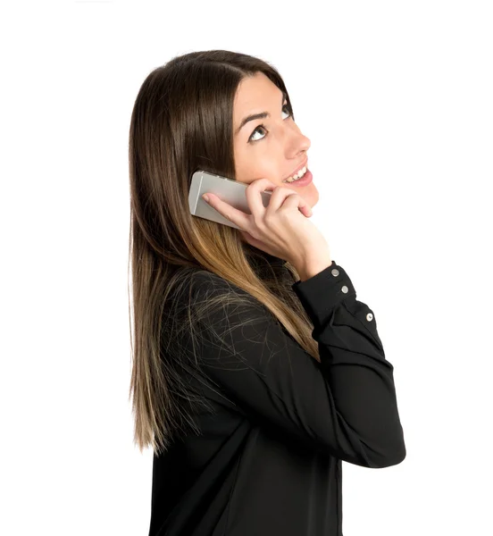 Menina conversando com celular sobre fundo isolado . — Fotografia de Stock