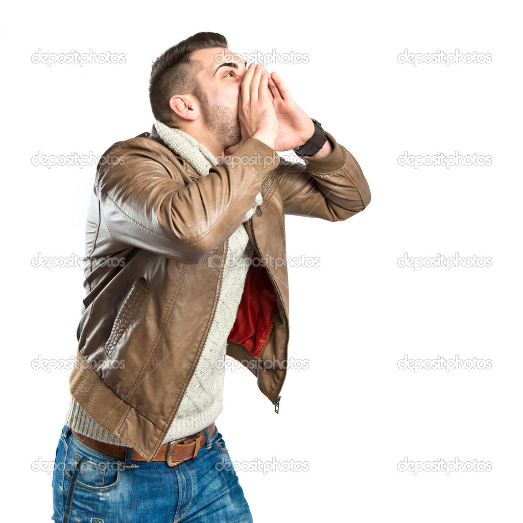 Young man screaming over isolated white background