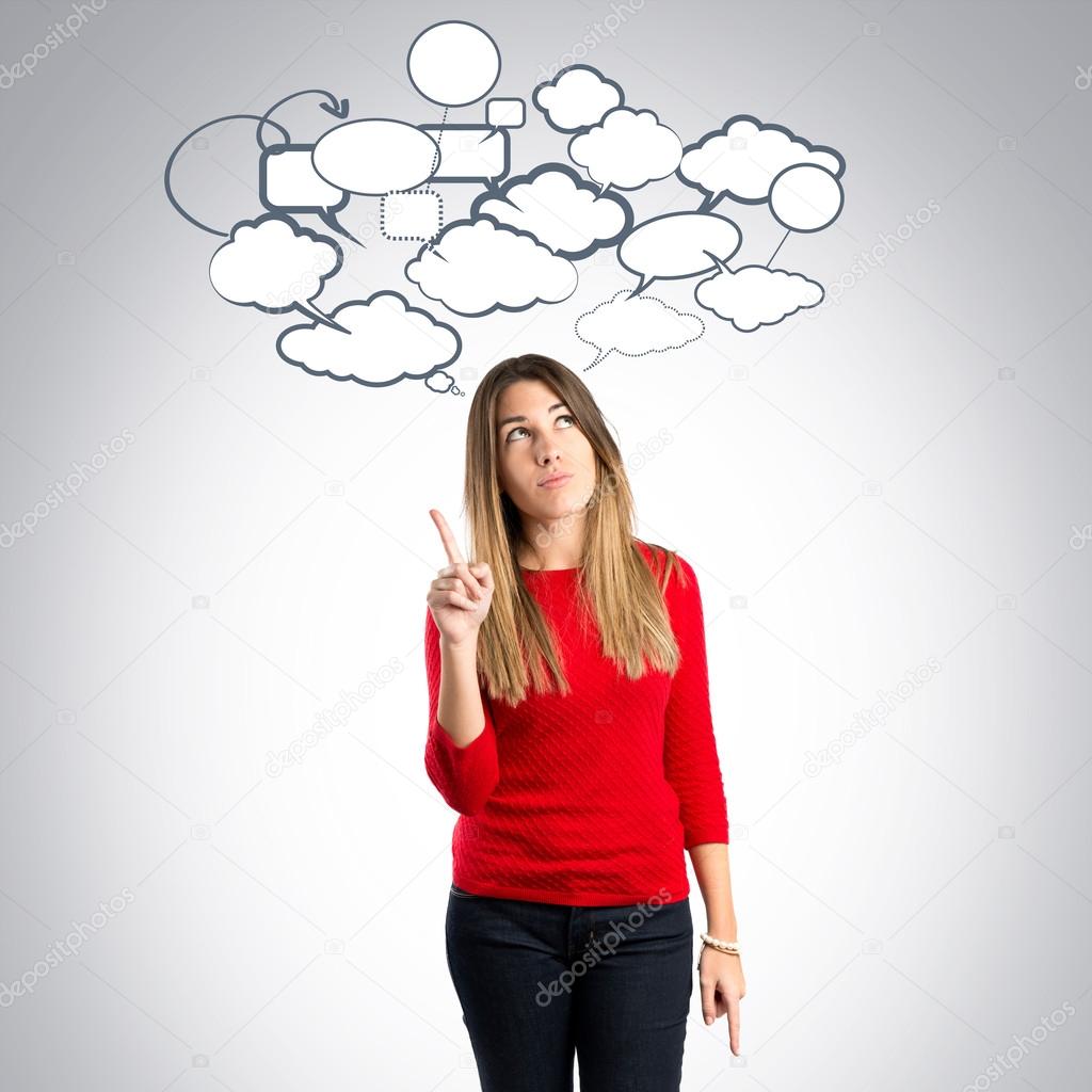 Cute young girl thinking an idea over grey background