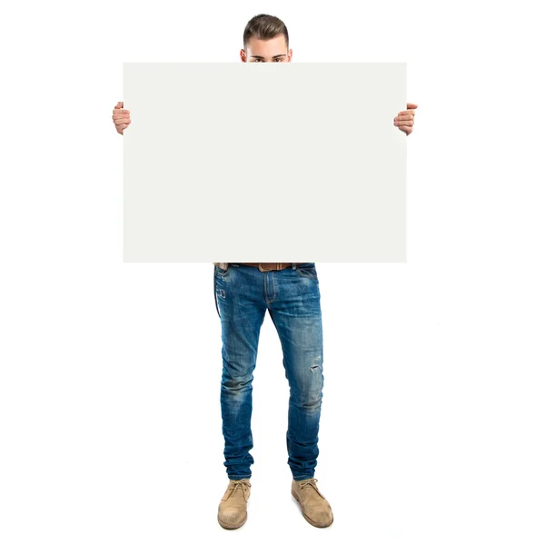 Handsome man holding an empty cardboard over white background — Stock Photo, Image