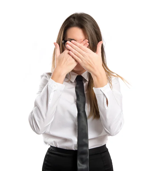 Young businesswoman covering her eyes over isolated white background — Stock Photo, Image