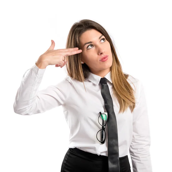 Young businesswoman making suicide gesture over white background — Stock Photo, Image