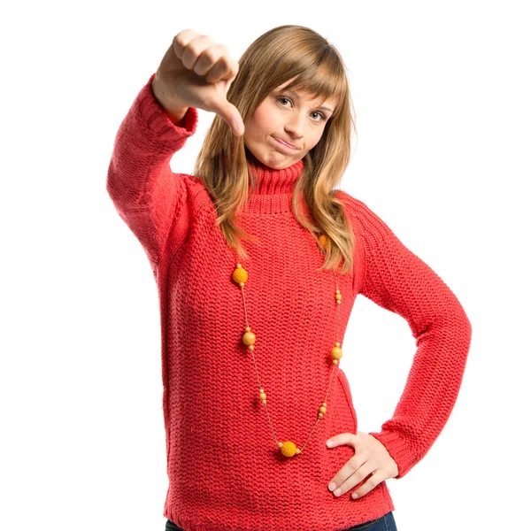 Young girl doing a bad signal over white background — Stock Photo, Image