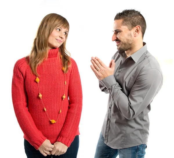 Men pleading at his girlfriend over white background — Stock Photo, Image