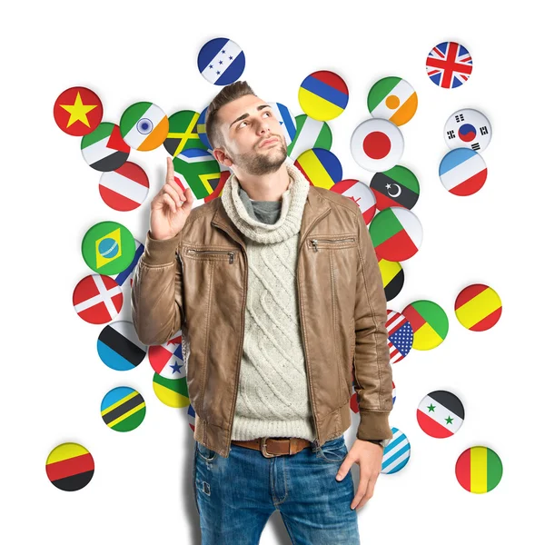 Young man thinking over background with flags — Stock Photo, Image