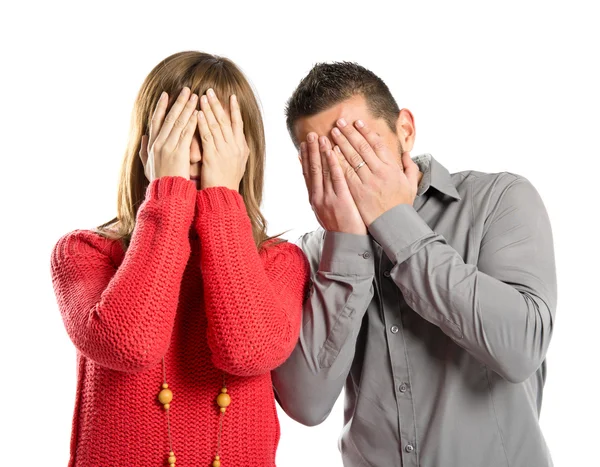 Couple covering their eyes over white background — Stock Photo, Image