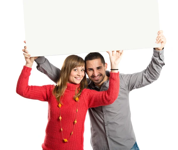 Casal segurando cartaz sobre fundo branco — Fotografia de Stock