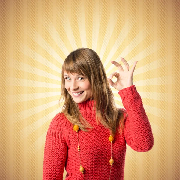 Young woman making Ok sign over yellow background — Stock Photo, Image