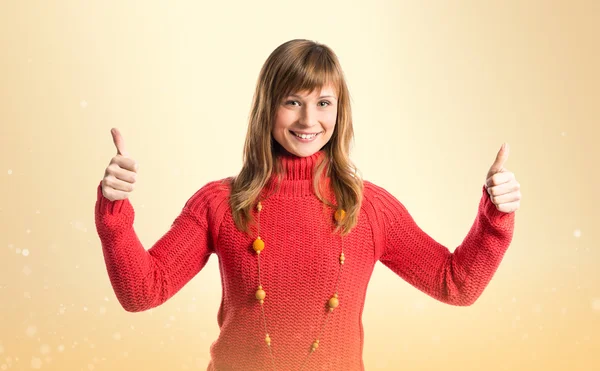 Young woman making Ok sign over yellow background — Stock Photo, Image