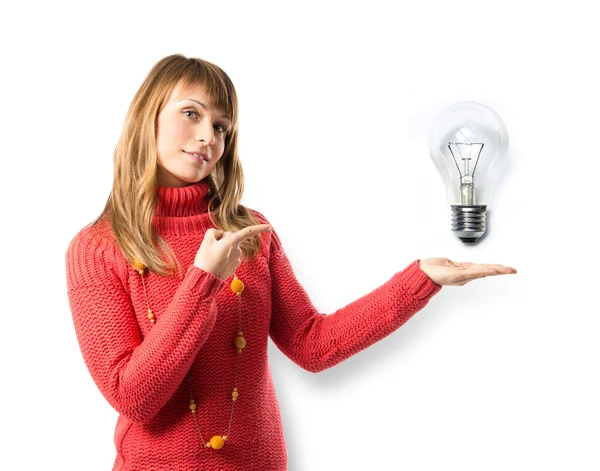 Young pretty woman pointing a bulb over white background — Stock Photo, Image