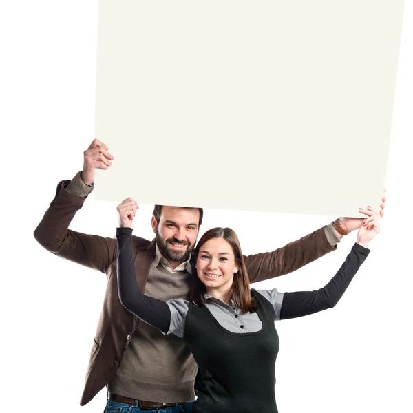 Casal segurando cartaz sobre fundo branco — Fotografia de Stock