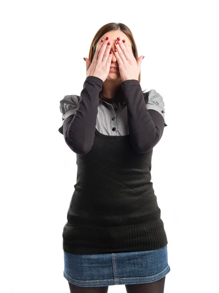 Young girl covering her eyes over isolated white background — Stock Photo, Image