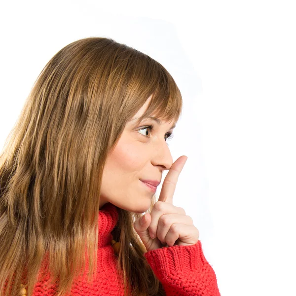 Jeune fille faisant un geste de silence sur fond blanc isolé — Photo