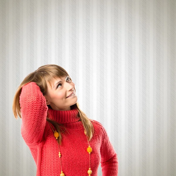 Young girl thinking over textured background — Stock Photo, Image