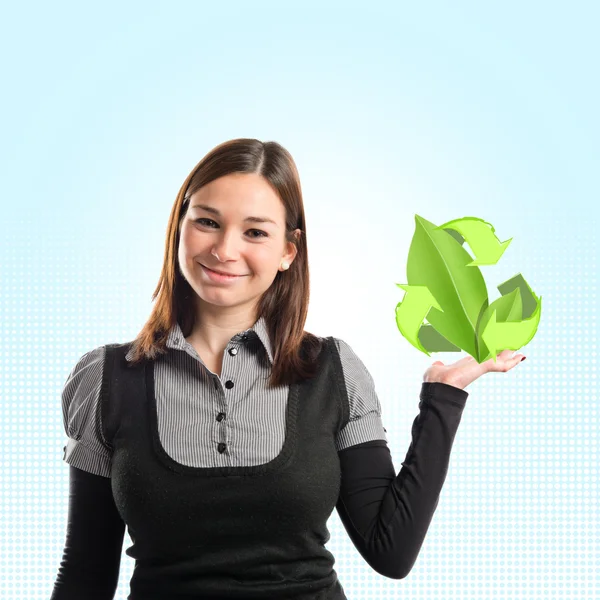 Young pretty woman holding eco recycle leaves over blue background — Stock Photo, Image