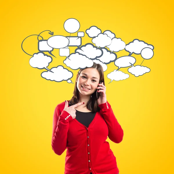 Young girl talking on mobile over yellow background — Stock Photo, Image