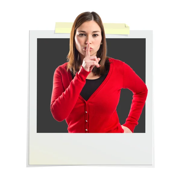 Young girl making silence gesture inside photo frame — Stock Photo, Image