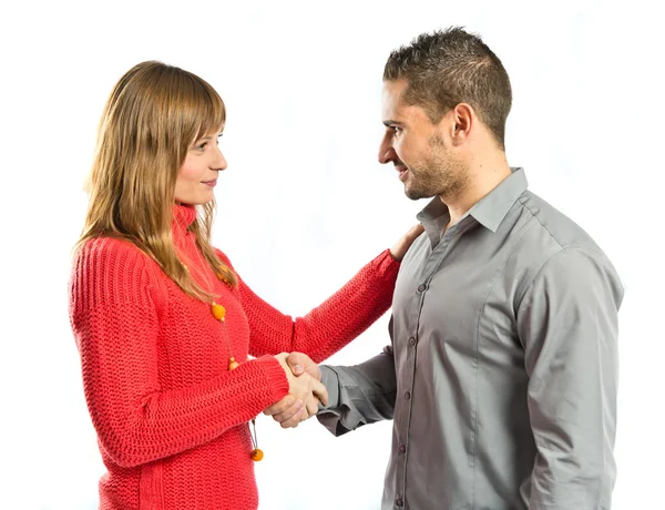 Couple making a deal over isolated white background — Stock Photo, Image