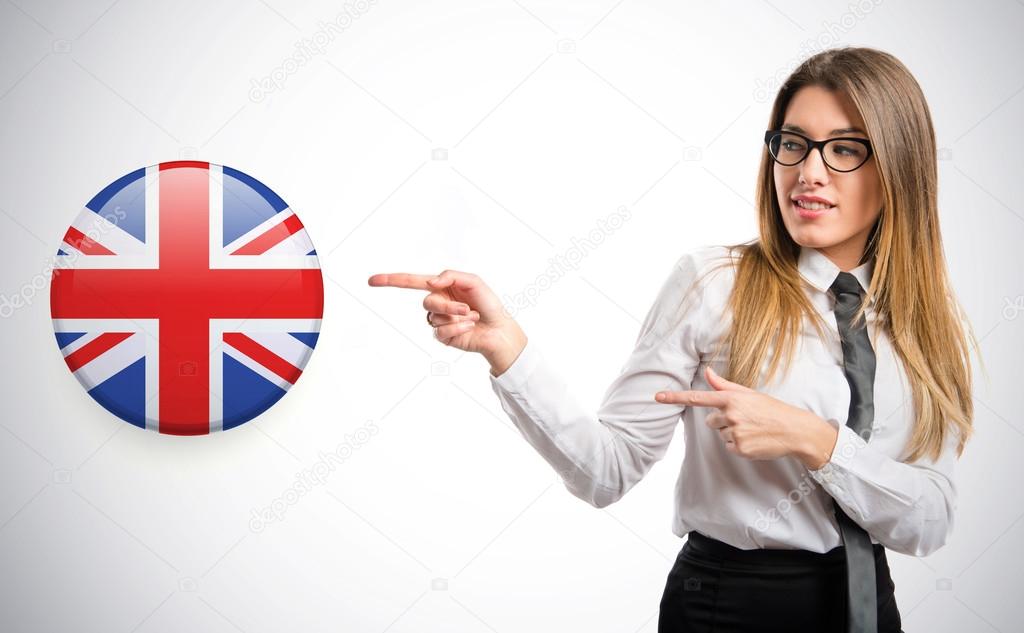 Young pretty businesswoman pointing an english icon over white background 