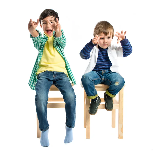 Kids doing the horn sign over white background — Stock Photo, Image