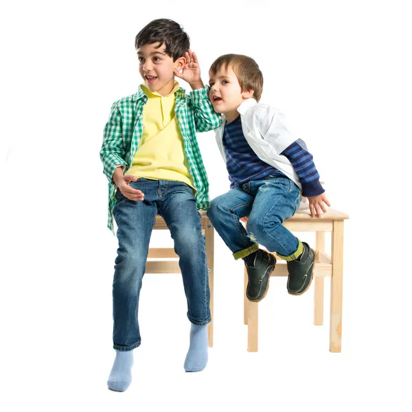 Kids whispering over white background — Stock Photo, Image