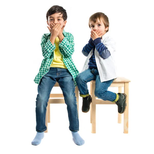 Kids covering his mouth over white background — Stock Photo, Image