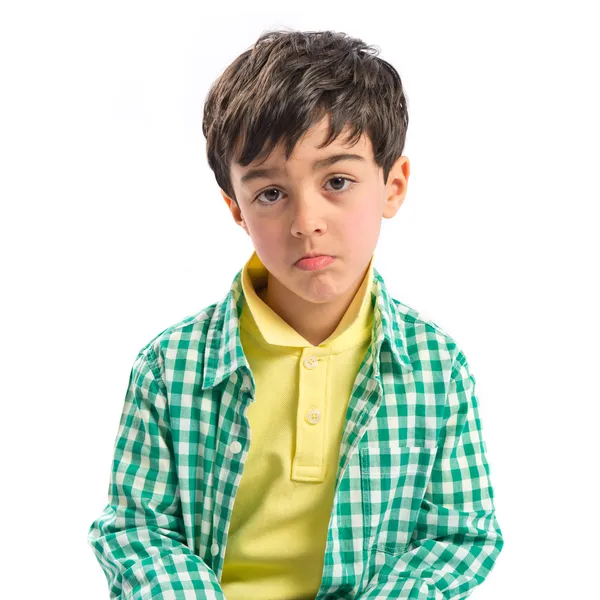 Sad brunette kid over isolated white background — Stock Photo, Image