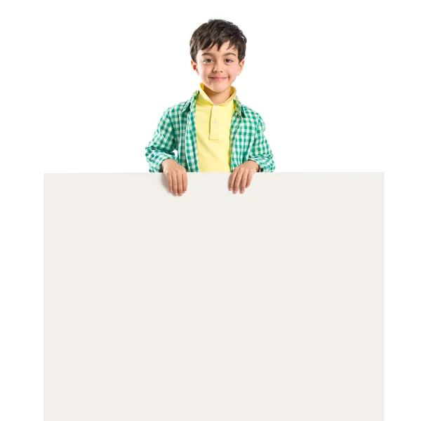 Kid segurando cartaz vazio sobre fundo branco — Fotografia de Stock