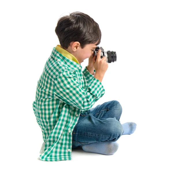 Boy photographing something over white background — Stock Photo, Image