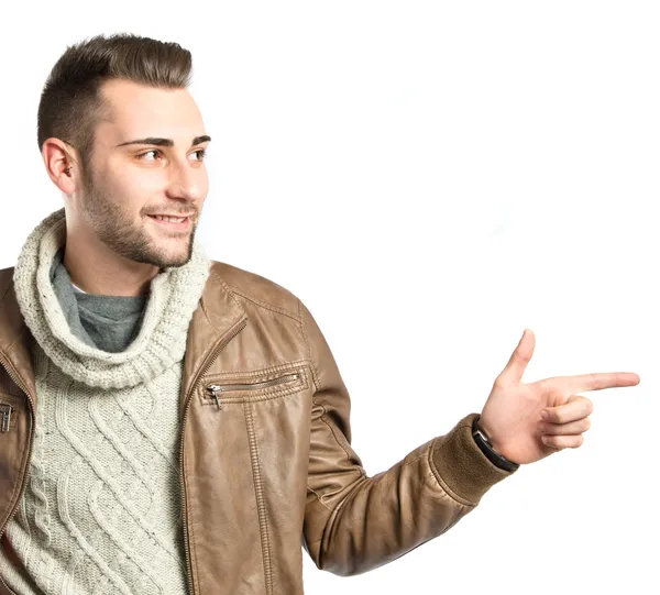 Young man pointing to his right over white background — Stock Photo, Image