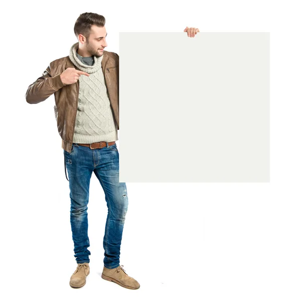 Handsome man holding an empty cardboard over white background — Stock Photo, Image