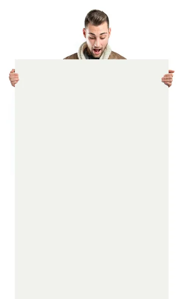 Handsome man holding an empty cardboard over white background — Stock Photo, Image