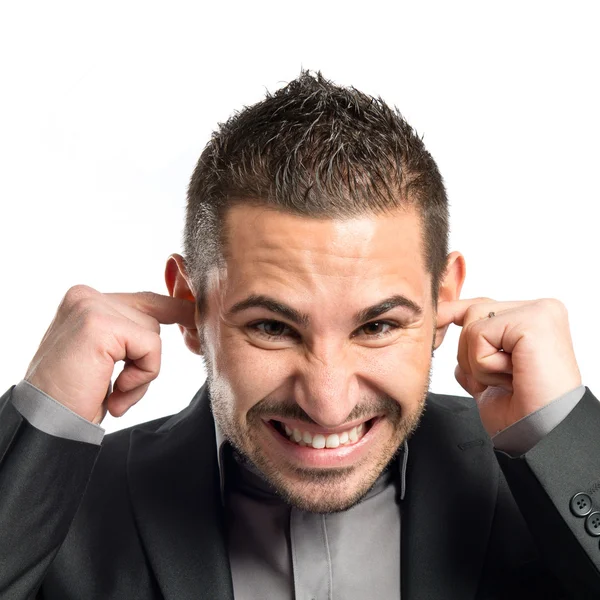 Hombre de negocios cubriendo sus oídos sobre fondo blanco — Foto de Stock