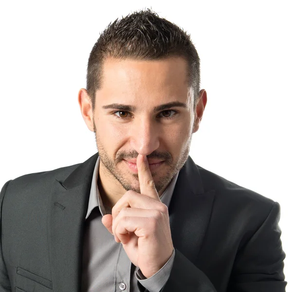 Joven haciendo un gesto de silencio sobre un fondo blanco aislado —  Fotos de Stock