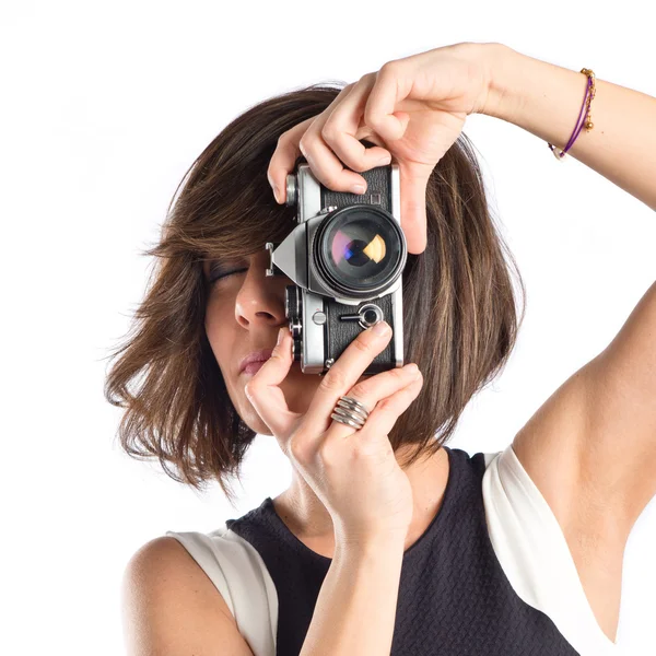 Chica tomando una foto sobre fondo blanco — Foto de Stock