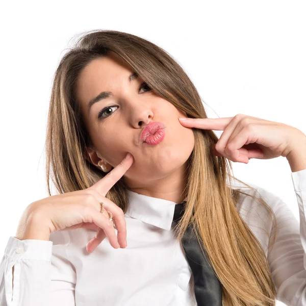 Menina bonita fazendo uma piada sobre fundo branco — Fotografia de Stock