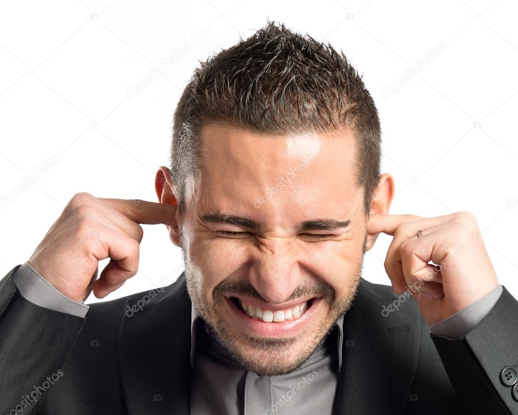 business man covering her ears over white background 