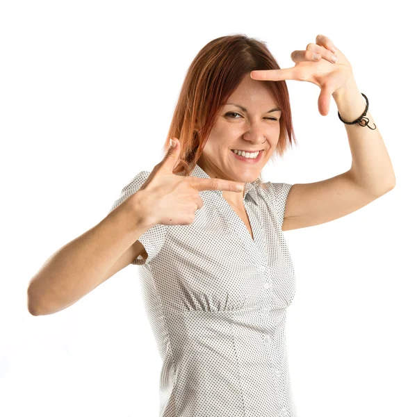 Young girl focusing with her fingers on a white background — Stock Photo, Image