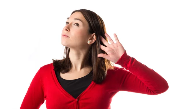 Young woman listening over isolated white background — Stock Photo, Image