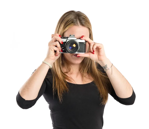 Menina tirando uma foto sobre fundo branco — Fotografia de Stock