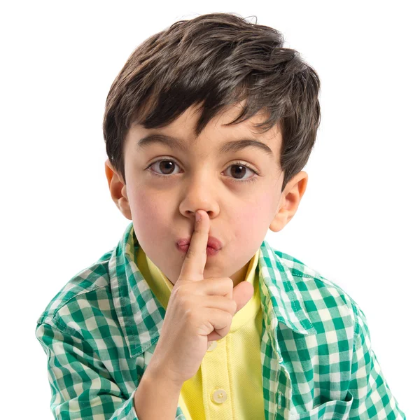 Niño haciendo gesto de silencio sobre fondo blanco —  Fotos de Stock