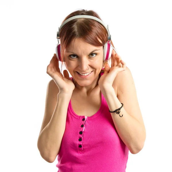 Chica joven escuchando música sobre fondo blanco —  Fotos de Stock