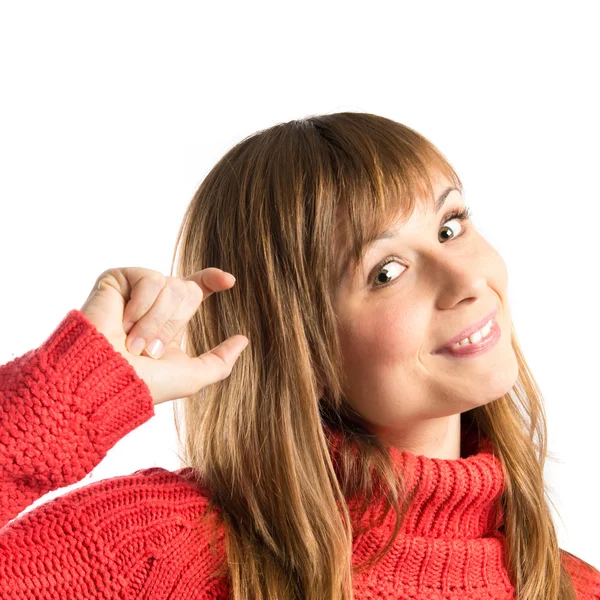 Jong meisje doen een klein teken op witte achtergrond — Stockfoto