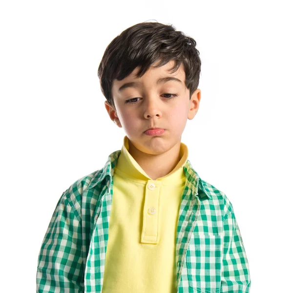 Sad brunette kid over isolated white background — Stock Photo, Image