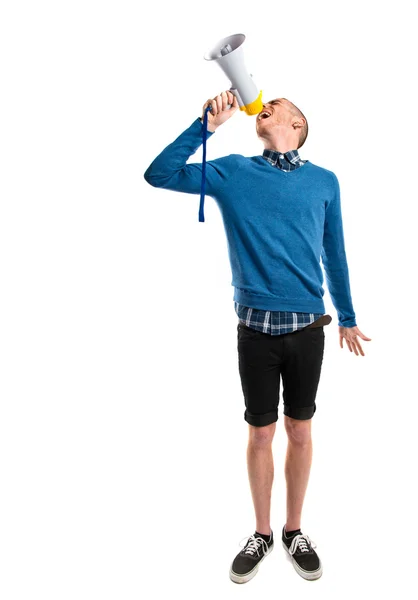 Redhead man shouting by megaphone over white background — Stock Photo, Image