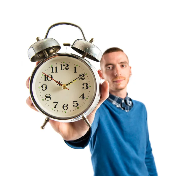 Redhead man holding an antique clock over white background — Stock Photo, Image