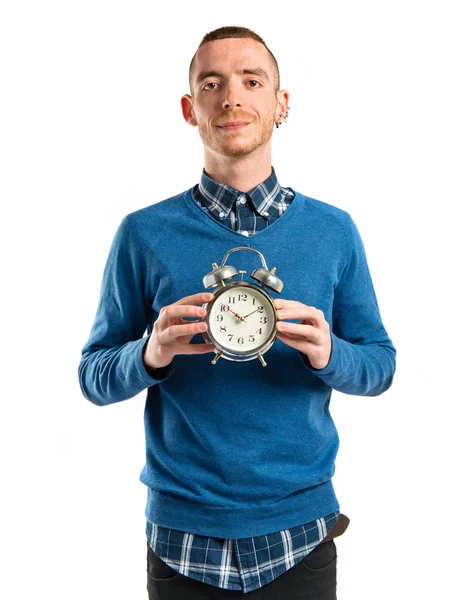 Redhead man holding an antique clock over white background — Stock Photo, Image