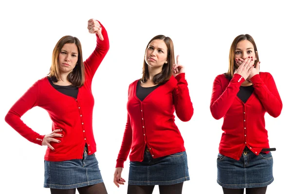 Young girl thinking, covering her mouth, and with her thumb down — Stock Photo, Image