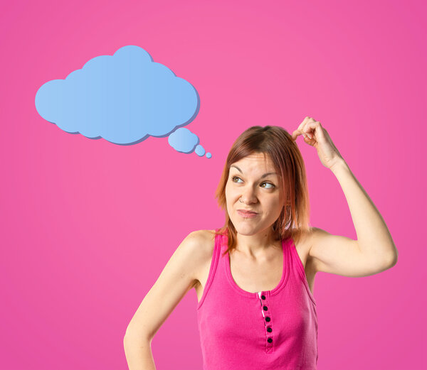 Cute young girl thinking an idea over pink background 